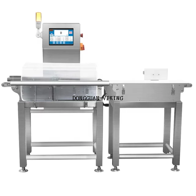 Dynamic in motion check weigher for dry fruit processing 